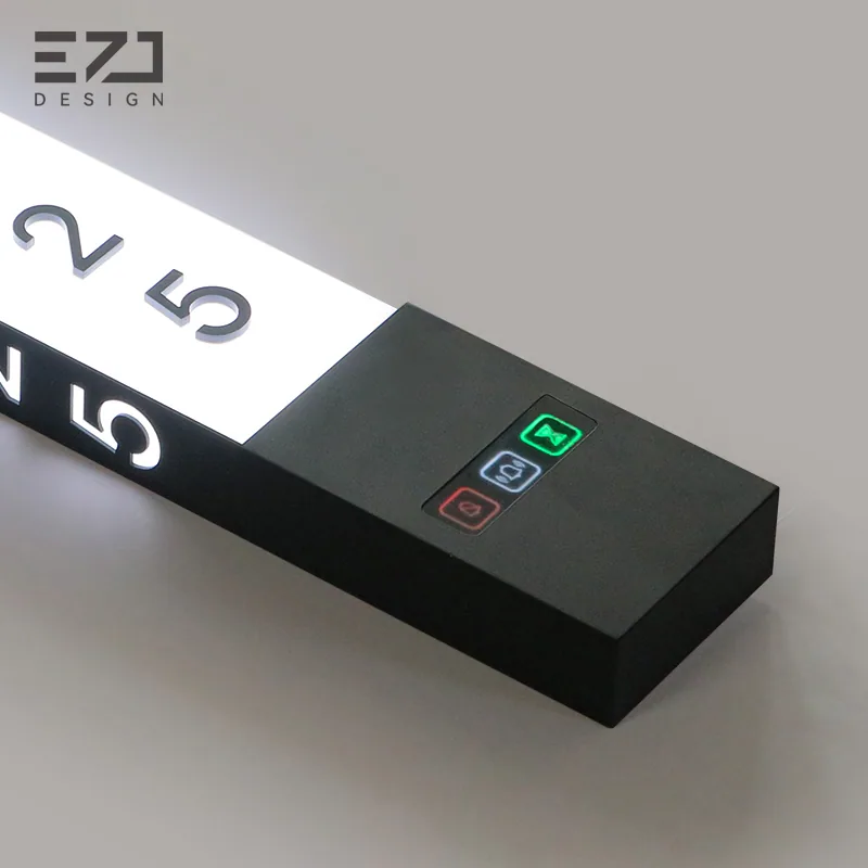 Close view of room numbers and visible status controls on a white side-light sign