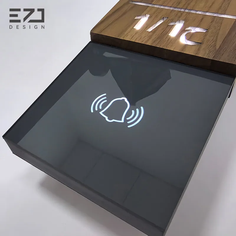 Close view of the visible bell symbol on a dark walnut-look door sign
