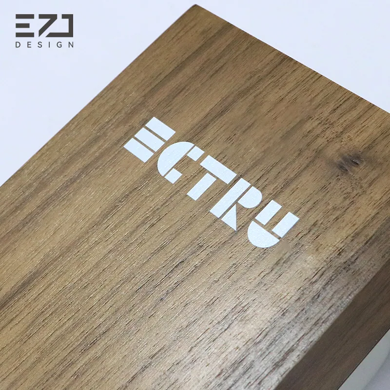 Close view of illuminated lettering on a dark walnut-look door sign