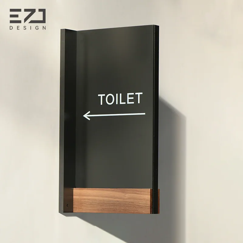 Black and wood-look restroom directional sign